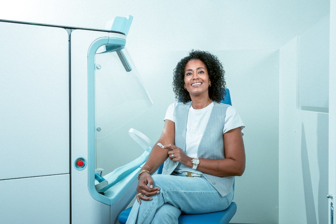 vrouw plakt pleister na prik van prikrobot