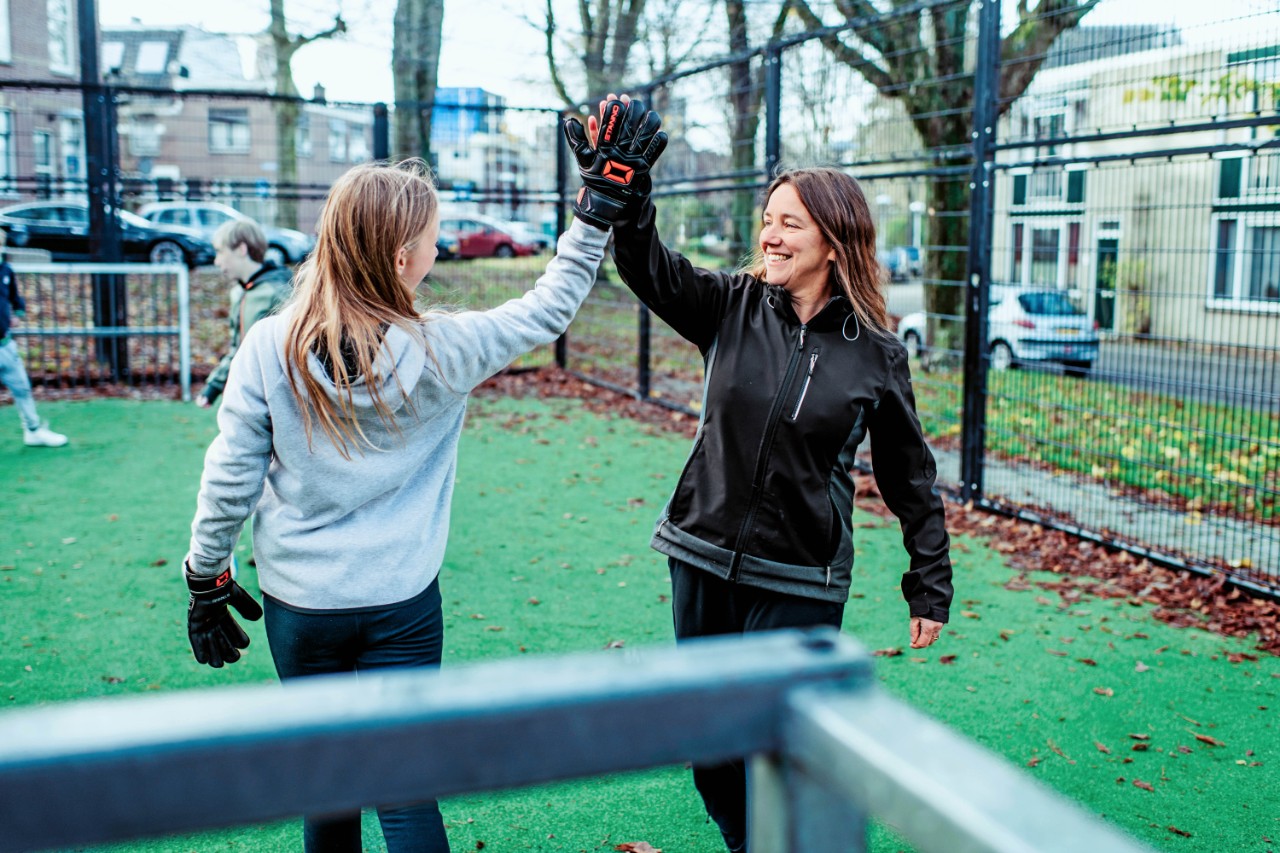 moeder en dochter high five voetballen