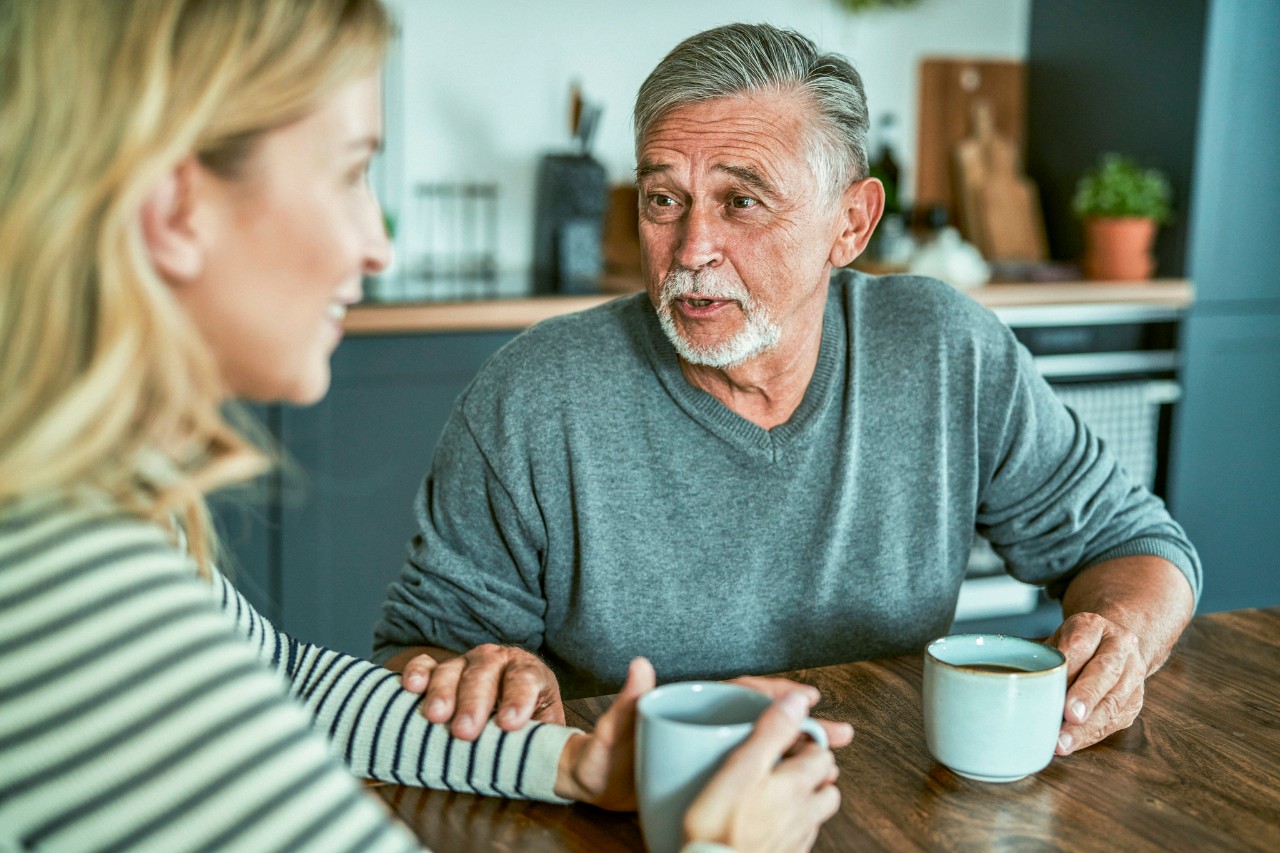 Senior man meeting with adult daughter at home